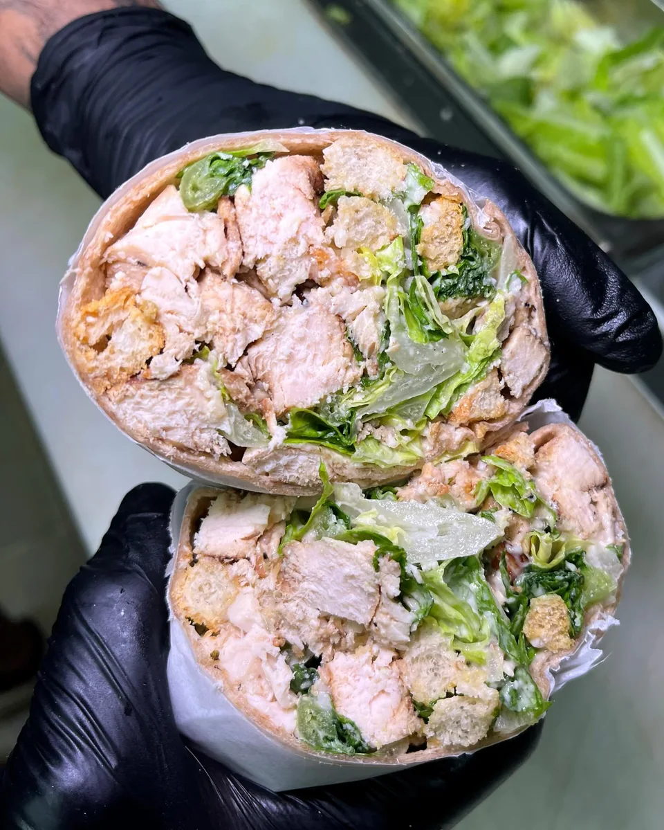 A generous chicken salad bagel sandwich