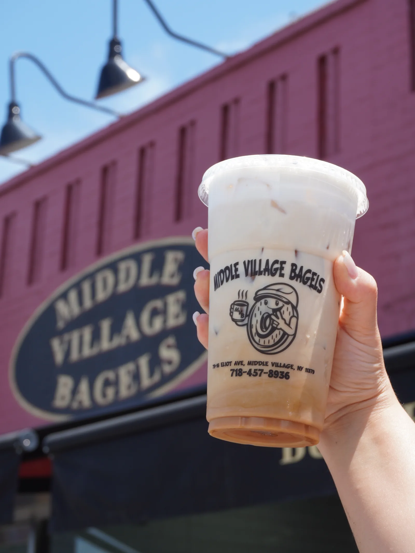 Iced cappuccino with the shop mascot on the cup